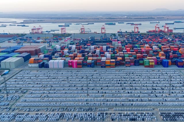 Contenedores y vehículos esperan su exportación en un puerto de Nanjing, provincia de Jiangsu (China), el 9 de diciembre de 2025. (AFP vía Getty Images)
