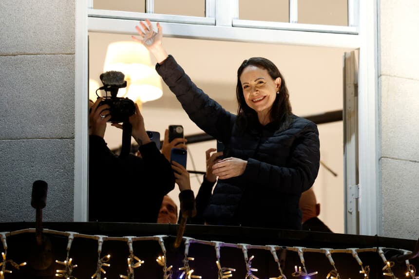 Nobel peace laureate Maria Corina Machado greets supporters from a balcony of the Grand Hotel in Oslo, Norway, early on December 11, 2025. Machado arrived in Oslo hours after the Venezuelan opposition leader's award was collected on her behalf by her daughter. (Photo by Odd ANDERSEN / AFP via Getty Images)