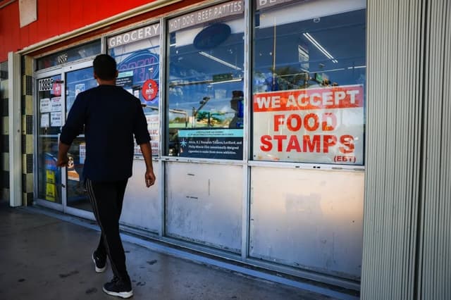 A 'We Accept Food Stamps' sign hangs in the window of a grocery store on October 31, 2025 in Miami, Florida. The food stamp program, now known as the Supplemental Nutrition Assistance Program (SNAP), may run out of funding on November 1st due to the federal government shutdown, which is now entering its second month. In Miami-Dade County, nearly one in six residents receives food assistance. (Photo by Joe Raedle/Getty Images)