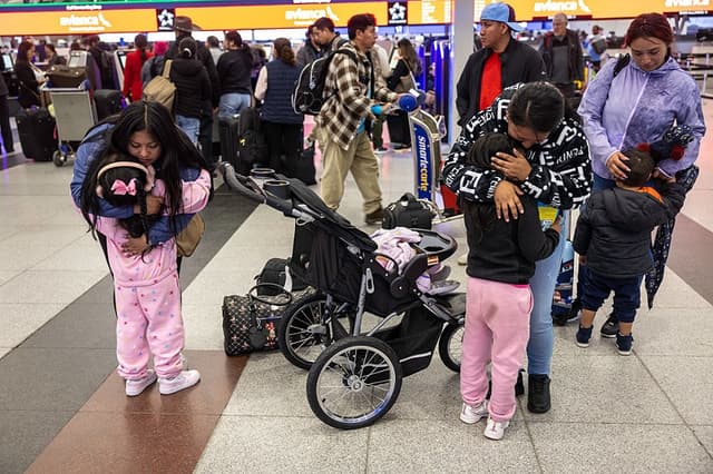 La inmigrante ecuatoriana Andrea y su hermana abrazan a sus respectivas sobrinas antes de que Andrea parta hacia Ecuador en el Aeropuerto Internacional JFK el 26 de octubre de 2025 en Nueva York, Nueva York. Andrea y su prima Jennyfer (derecha) decidieron "auto deportarse" con sus hijos (John Moore/Getty Images)