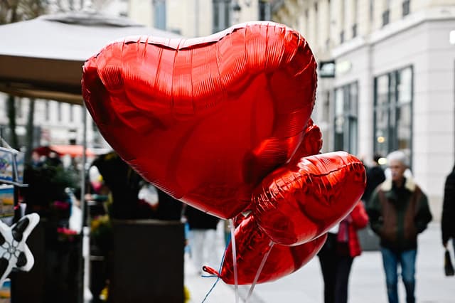 Tres globos en forma de corazón flotan en el viento frente a una tienda antes del Día de San Valentín en Lyon, Francia, el 6 de febrero de 2026. (Foto de Matthieu Delaty / Hans Lucas / AFP a través de Getty Images)