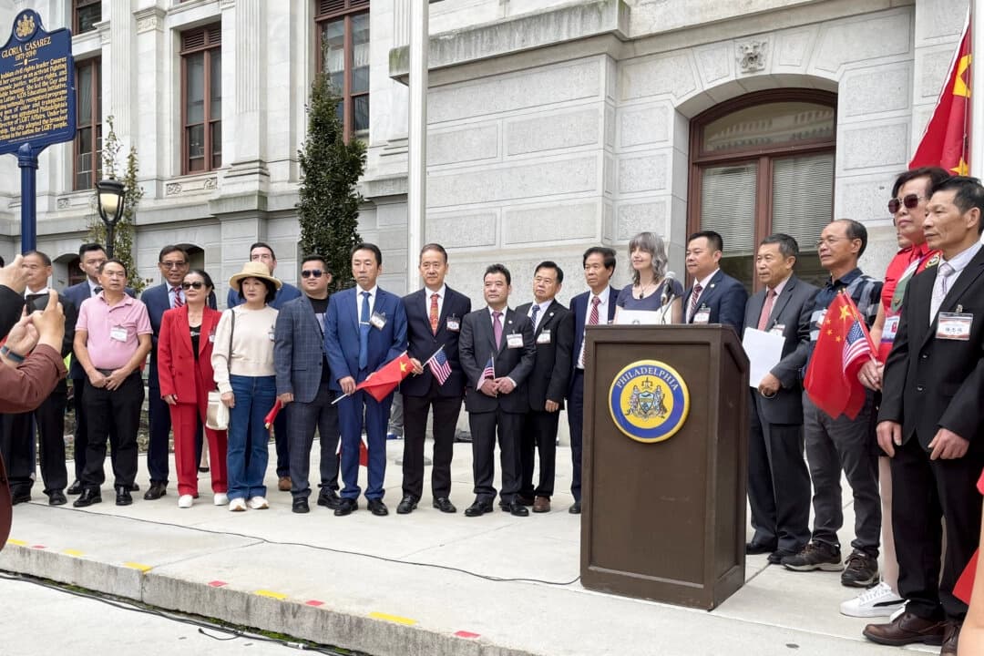 Miembros de la Asociación de Chinos de Ultramar en el acto de izamiento de la bandera en conmemoración de la fundación de la China comunista frente al Ayuntamiento de Filadelfia el 30 de septiembre de 2025. (The Epoch Times)