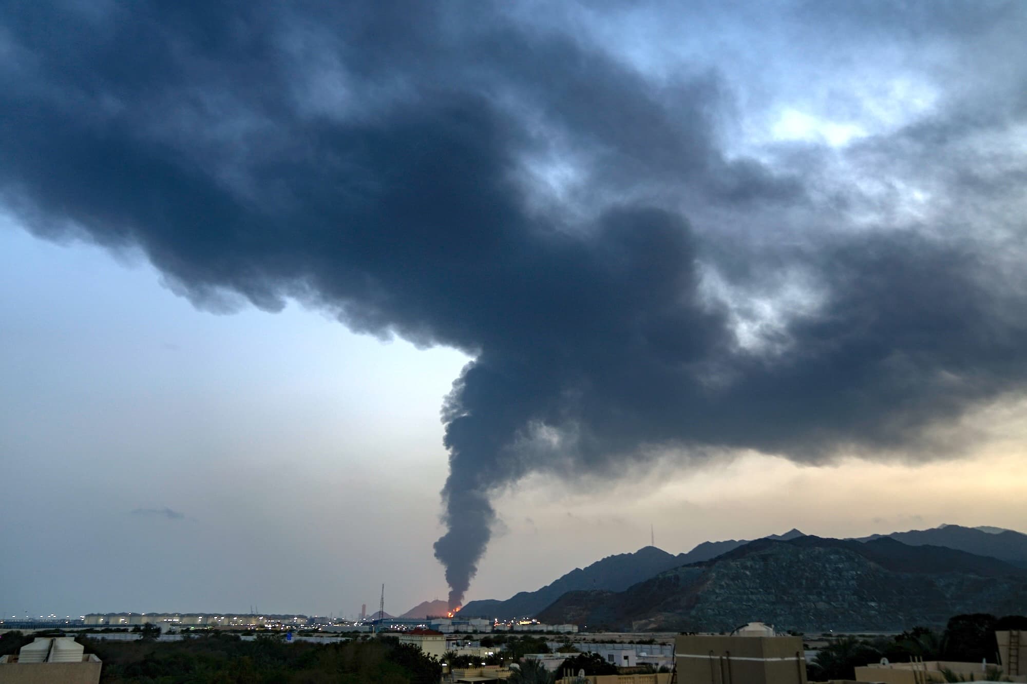 Se puede ver un gran incendio y una columna de humo después de que los restos de un dron iraní impactaran en una instalación petrolera, en Fujairah, Emiratos Árabes Unidos, el 3 de marzo de 2026. (AP Photo/Altaf Qadri)