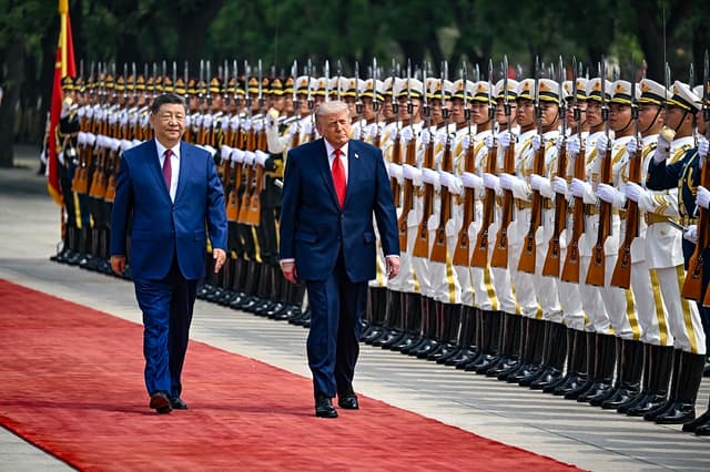 El presidente de Estados Unidos, Donald Trump, pasa revista a la guardia de honor junto al presidente chino, Xi Jinping, durante una ceremonia de bienvenida celebrada en el Gran Salón del Pueblo el 14 de mayo de 2026 en Beijing, China. (Kenny Holston-Pool/Getty Images)