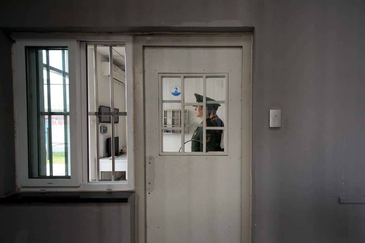 Un guardia paramilitar se encuentra junto a una puerta de seguridad en el Centro de Detención n.º 1 durante una visita guiada organizada por el gobierno en Beijing el 25 de octubre de 2012. (Ed Jones/AFP vía Getty Images)