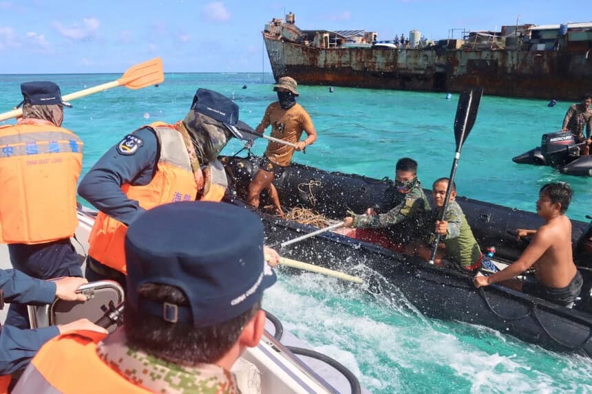 Miembros de la Armada de Filipinas y de la Guardia Costera de China se enfrentan cerca de un buque de guerra filipino encallado en el Segundo Banco de Thomas, en el Mar de China Meridional, el 20 de julio de 2026. (cnsphoto vía Reuters).