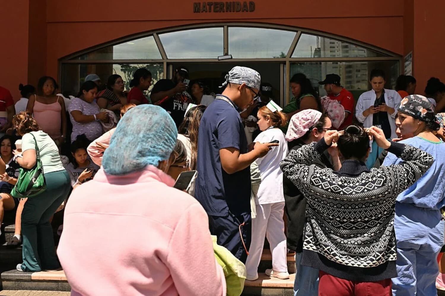 Varias personas se encuentran frente a la unidad de maternidad del hospital de Santo Tomás, tras el fuerte terremoto de magnitud 8 que sacudió el país, en la Ciudad de Panamá el 9 de octubre de 2026. (MARTIN BERNETTI / AFP vía Getty Images)